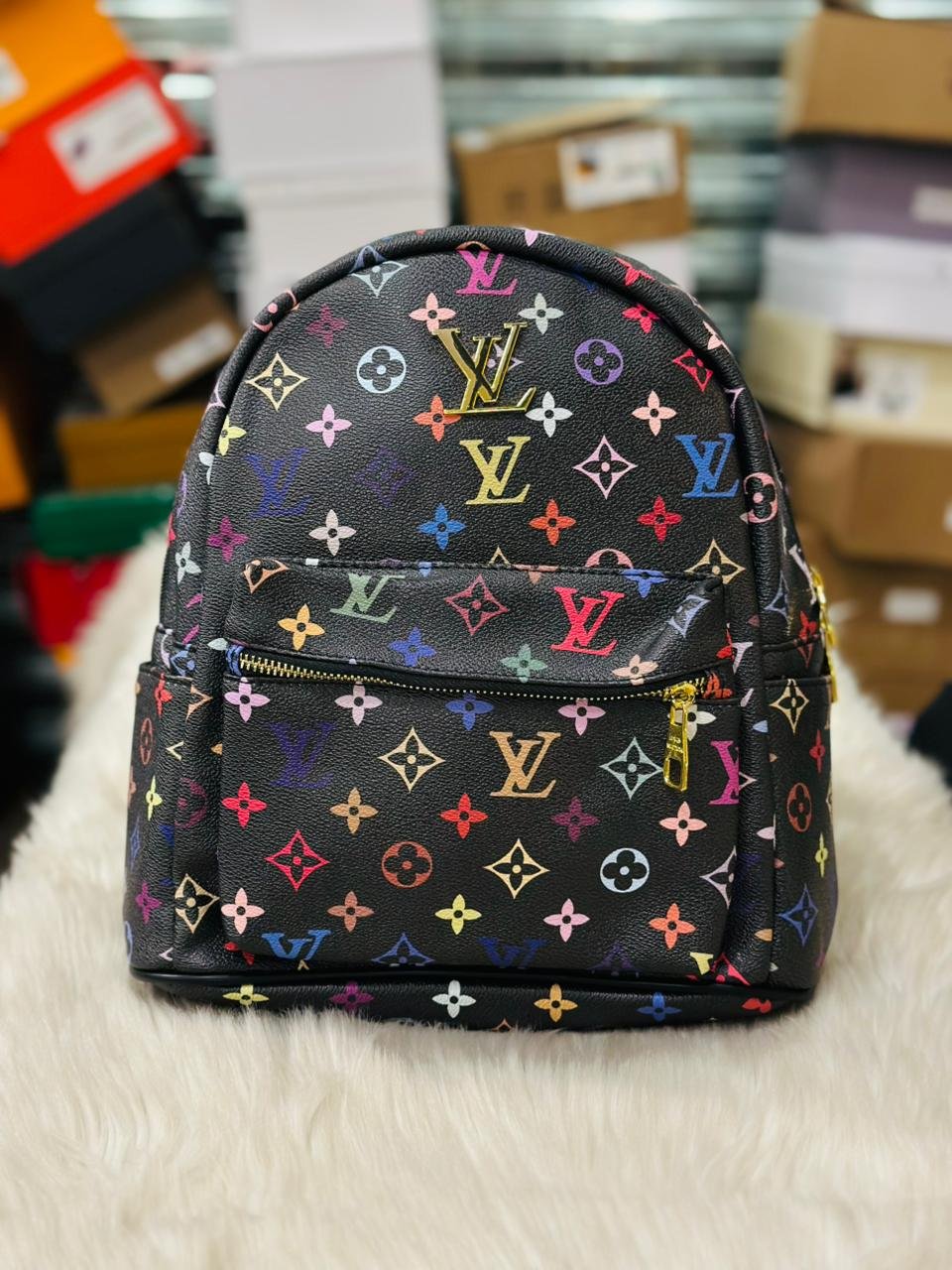 Louis Vuitton Mini Backpack in a Black Colorway with Multicolored Logos.